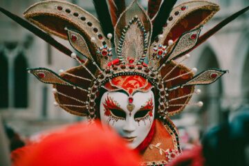 person wearing white and orange volto mask